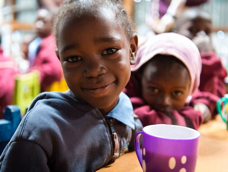 two young girls smiling at the camera