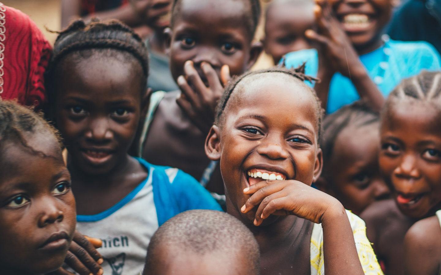a group of smiling children in a developing country
