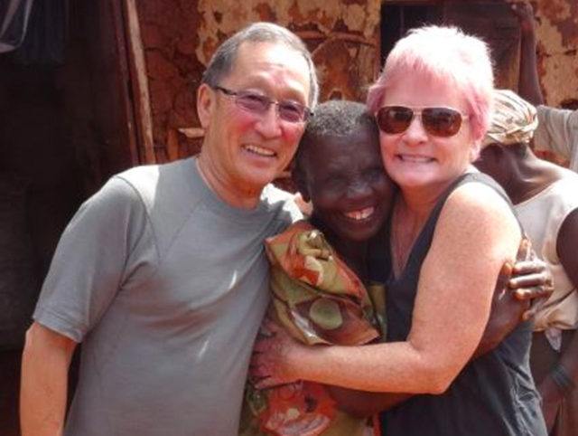 volunteers Val and Terry posing with a woman in a developing country