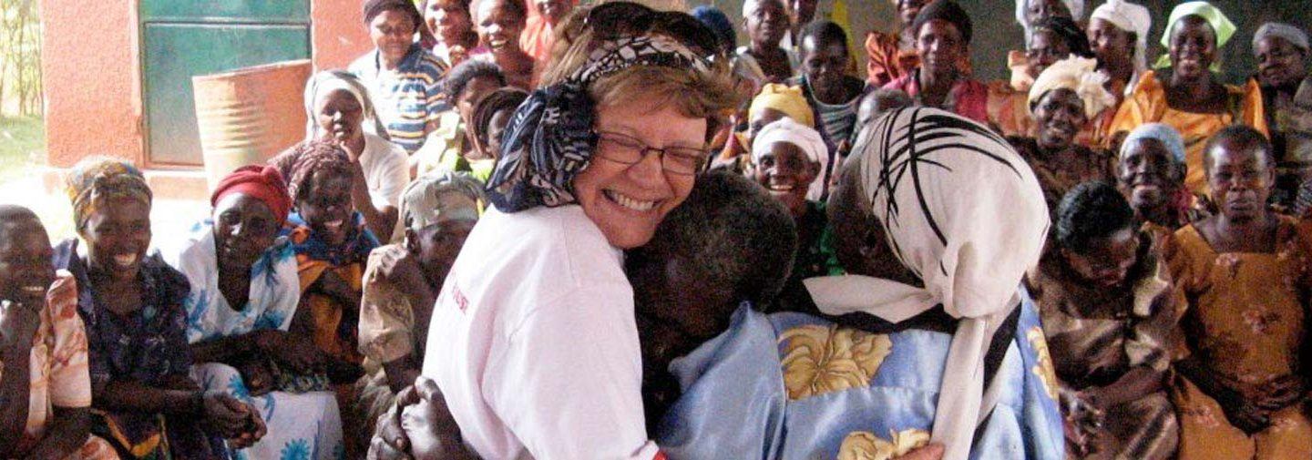 three women hugging in celebration as part of the Grandmothers Initiative