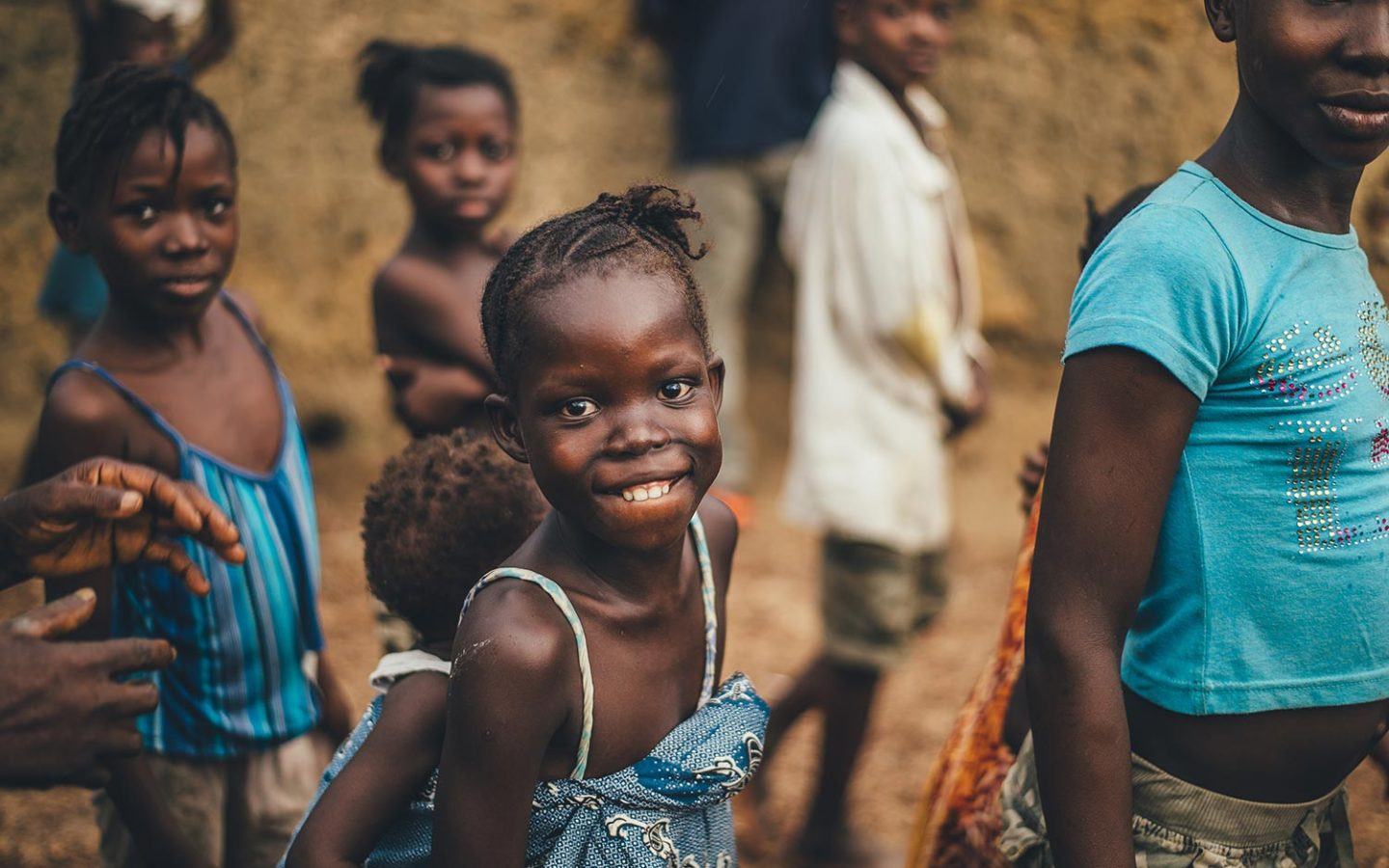 a group of young children in Kenya smiling a the camera