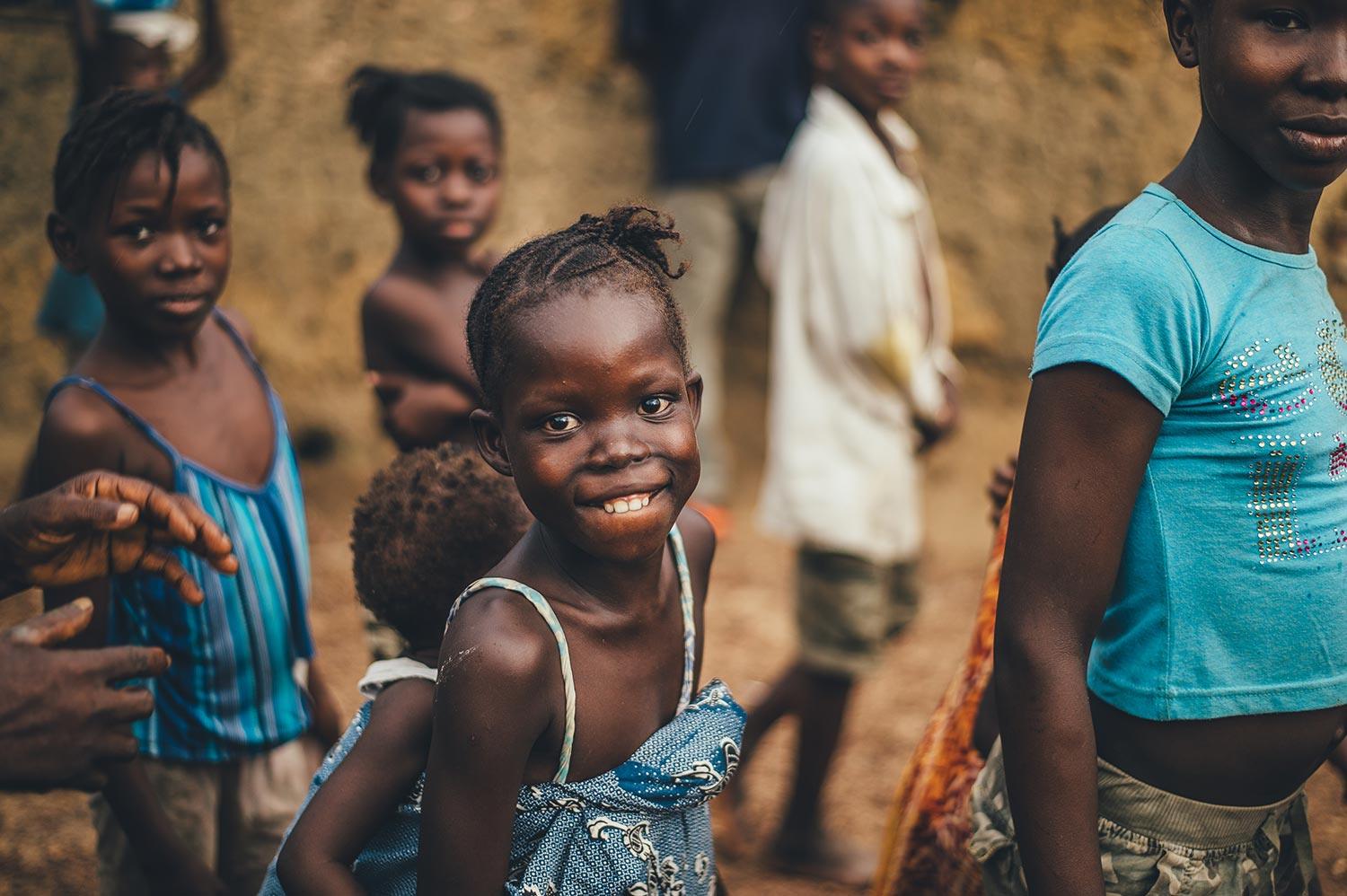 a group of young children in Kenya smiling a the camera