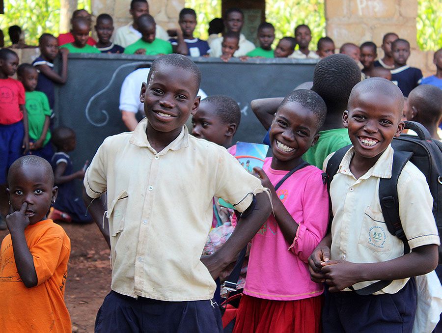 a group of smiling schoolchildren in a developing country