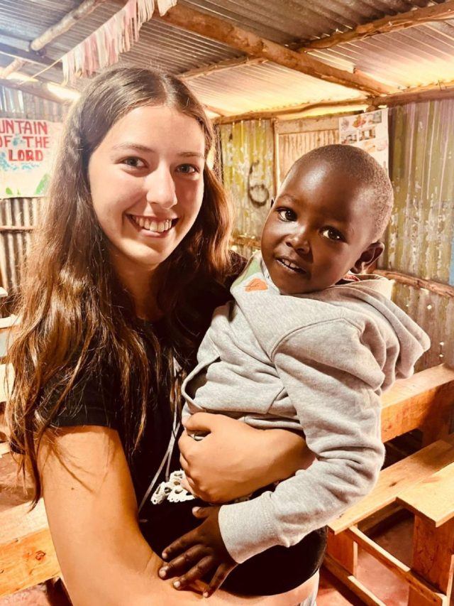 a woman holding a small child in her arms